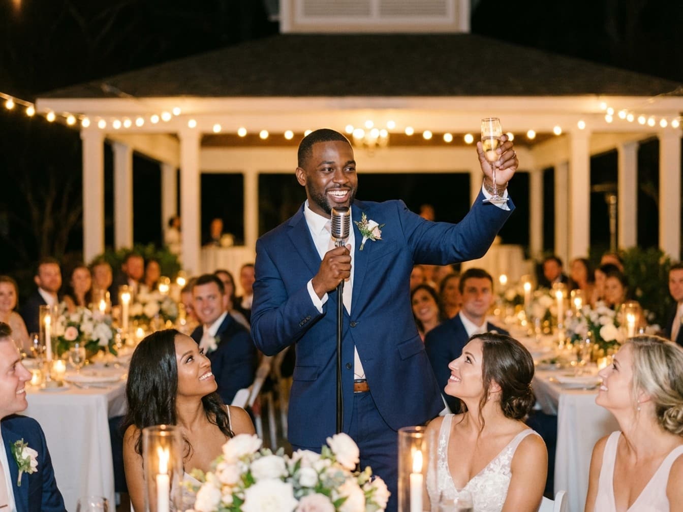 Man confidently delivering his wedding speech to an attentive room